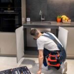 Searching for problem. Back view of man in white tshirt and blue