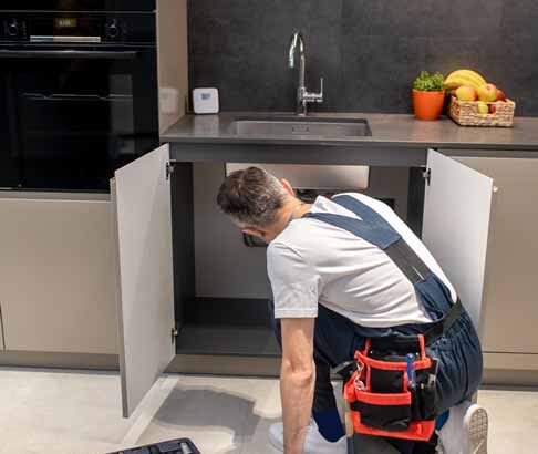 Searching for problem. Back view of man in white tshirt and blue